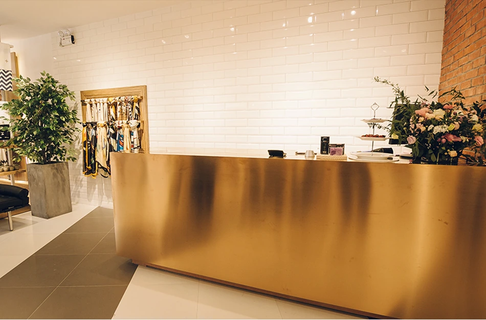 Valester showroom reception with a gold counter