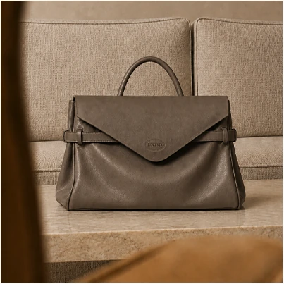 Taupe envelope handbag displayed on a chair